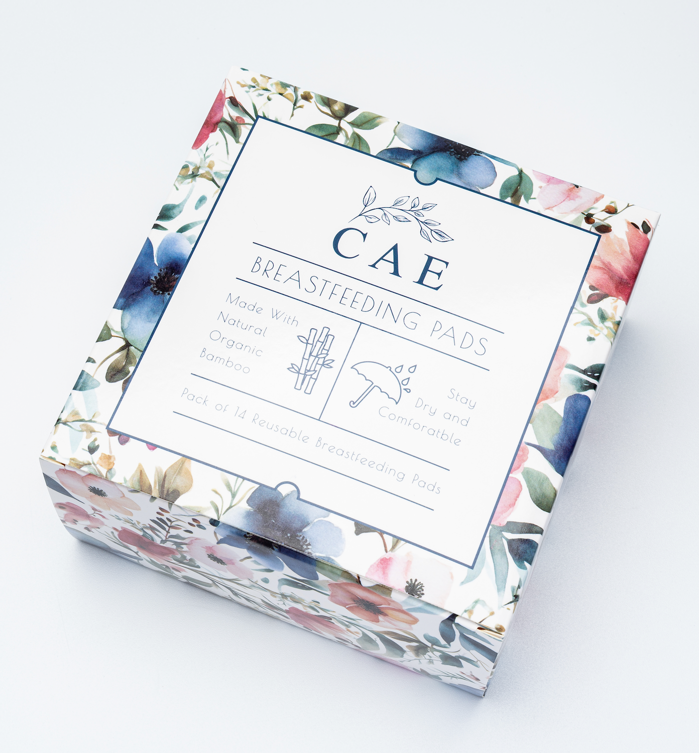 A box of CAE brand nursing pads with a floral pattern on the packaging.